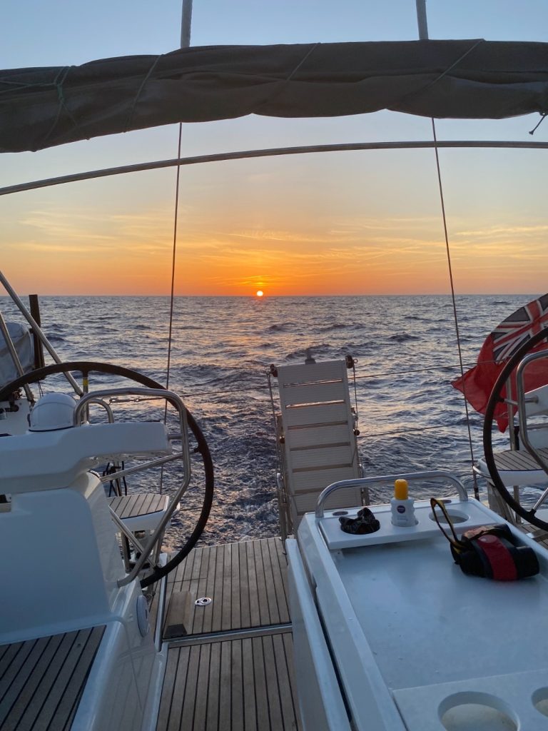 Sailing towards the sunset on an offshore passage