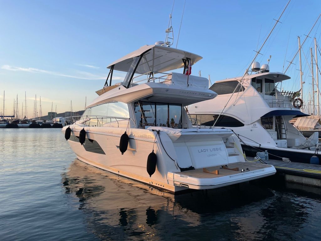 a motor yacht moored up at sunset after teaching the owners